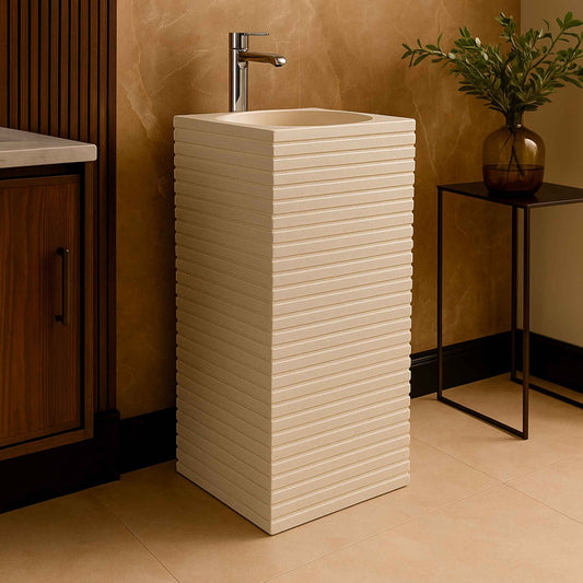 Pedestal basin in modern bathroom with wood vanity and marble wall