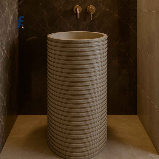 Front view of textured pedestal wash basin with stone finish in a luxury bathroom setting