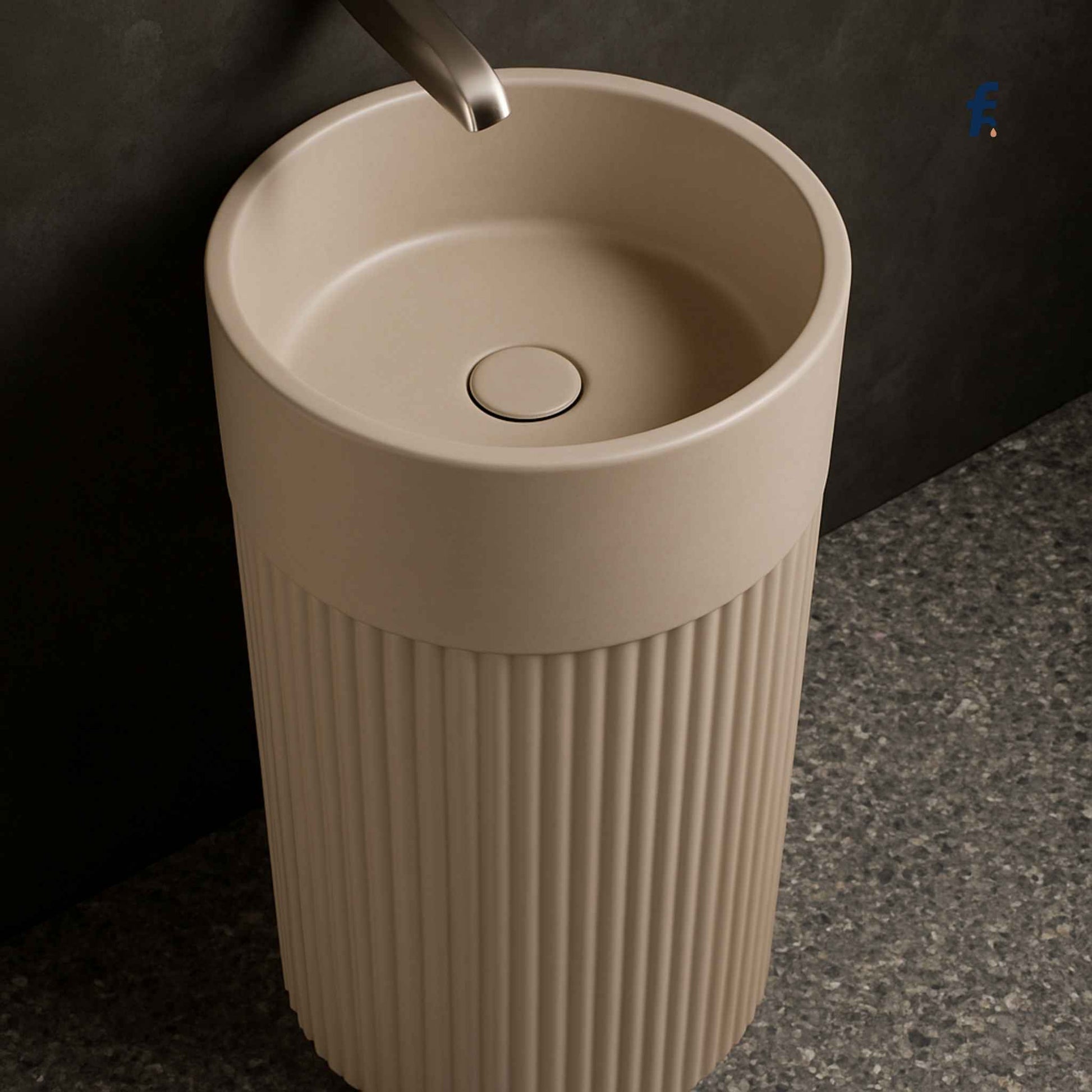 Beige freestanding sink with ribbed design on a dark background