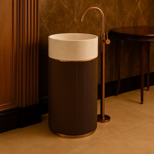 Pedestal basin in modern bathroom with gold standing faucet