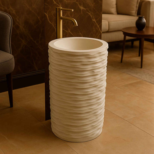 Designer bathroom featuring wave-cut pedestal basin with gold faucet