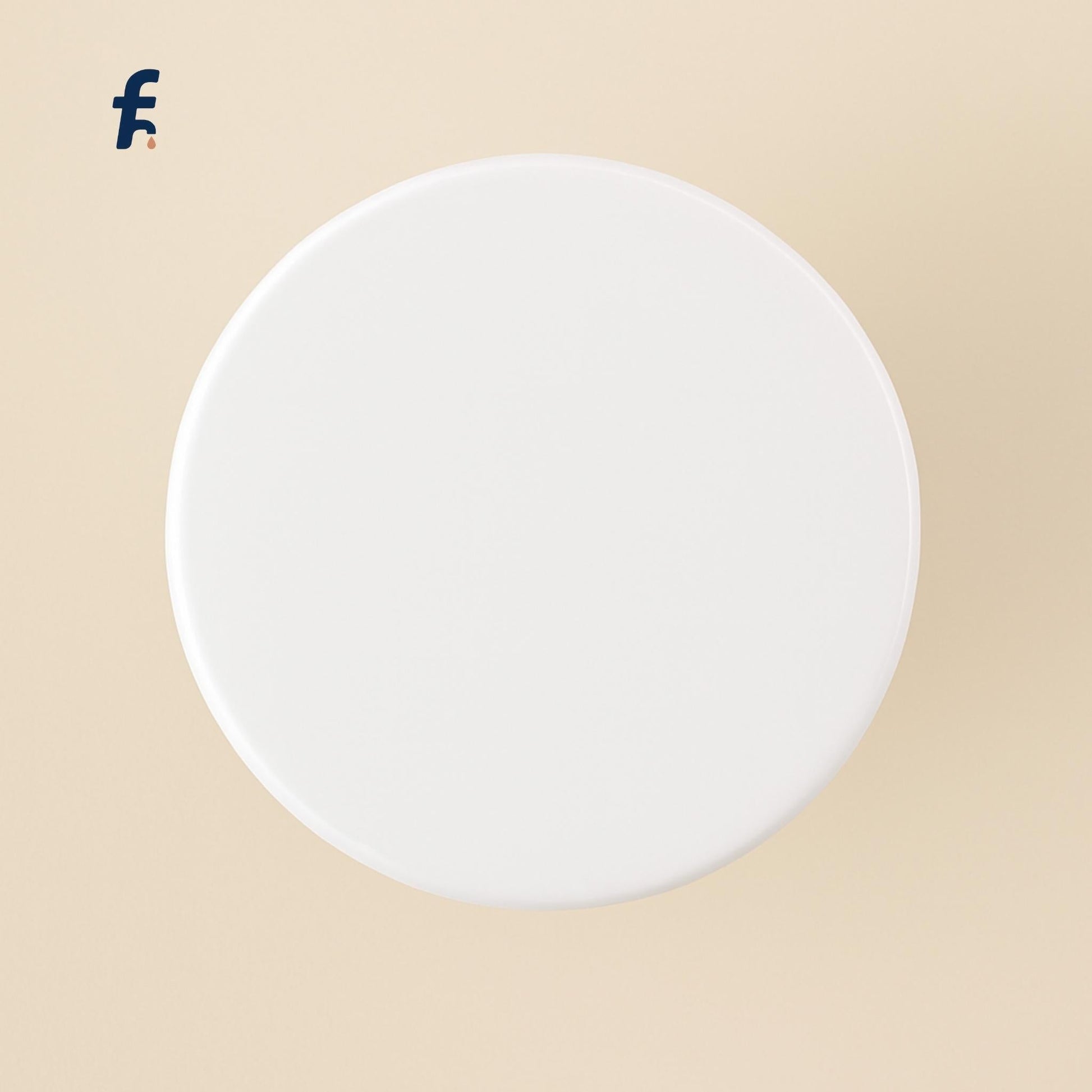 Top-down view of white glossy pop-up drain stopper