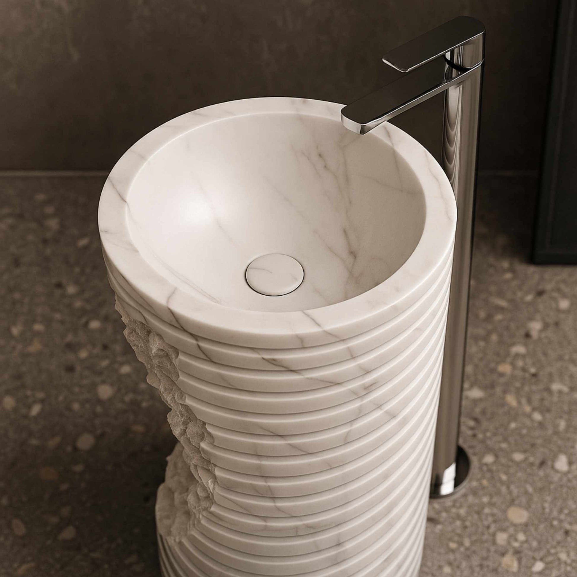 Top view of round marble wash basin with natural veins and chrome tap