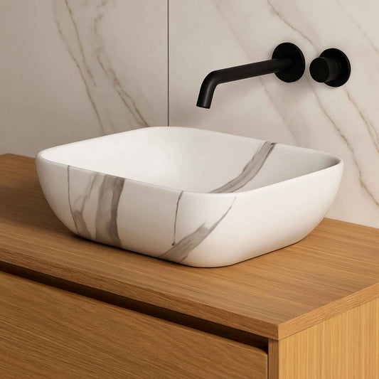 Front view of luxury white marble wash basin with grey and caramel vein pattern on countertop vanity