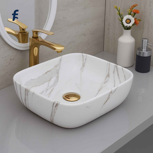 18x13 white marble finish wash basin with grey veins – front angle view with gold faucet
