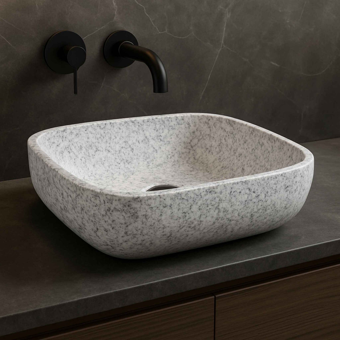 Front view of rectangular white speckled granite bathroom wash basin on dark marble vanity
