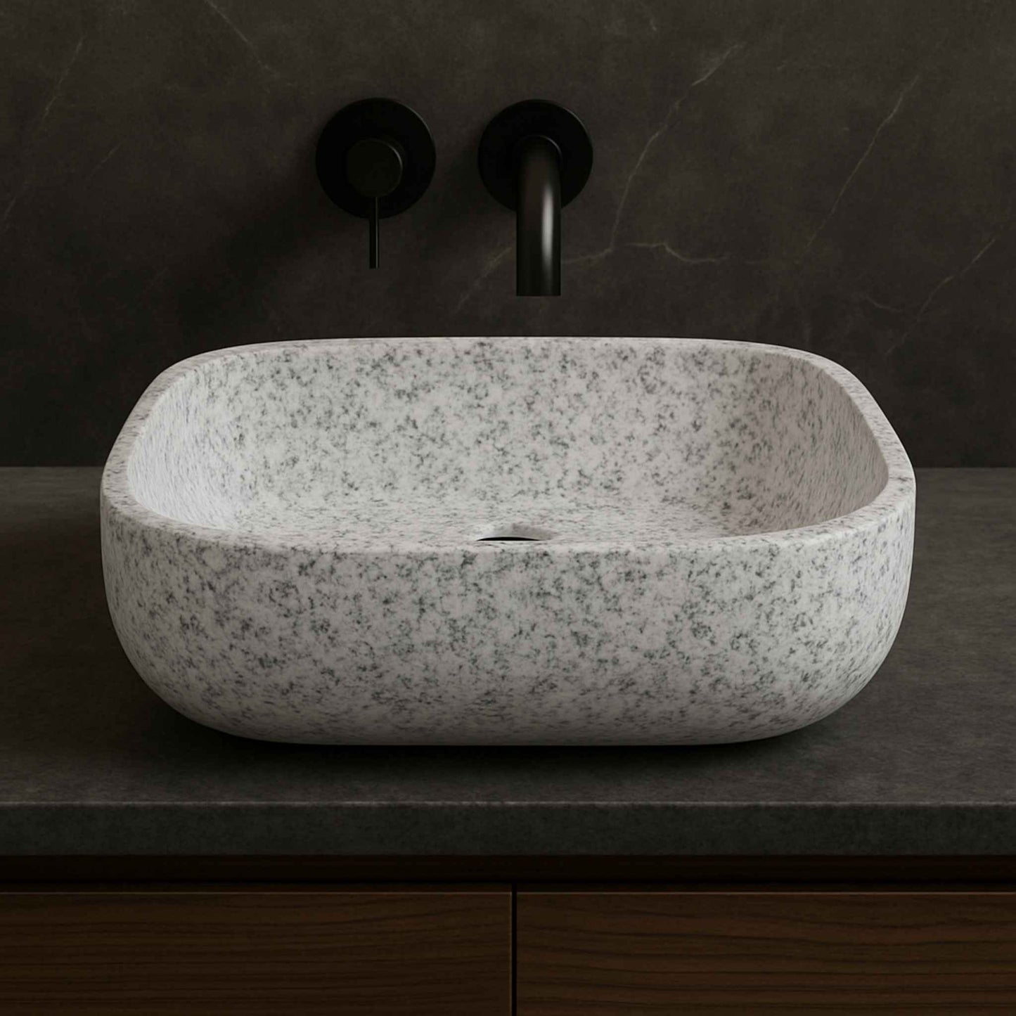 Side view of white granite textured bathroom basin with matte black faucet